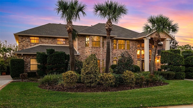 132 Pleasant Valley Dr, Daytona Beach, FL 32114 - view of front of house featuring brick siding, a lawn, and roof with shingles