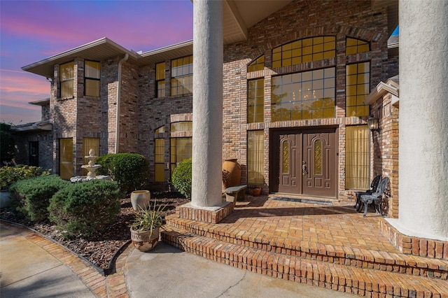 132 Pleasant Valley Dr, Daytona Beach, FL 32114 - exterior entry at dusk featuring brick siding