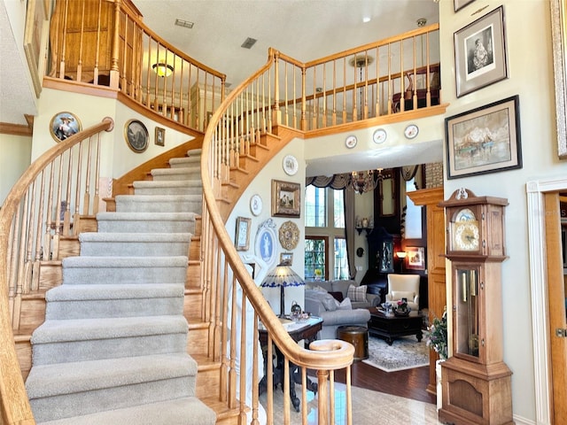 132 Pleasant Valley Dr, Daytona Beach, FL 32114 - staircase featuring a high ceiling and wood finished floors