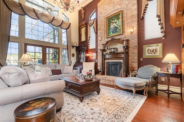 132 Pleasant Valley Dr, Daytona Beach, FL 32114 - living room featuring a wealth of natural light, a towering ceiling, wood finished floors, and a fireplace
