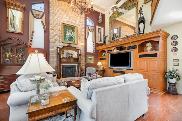 132 Pleasant Valley Dr, Daytona Beach, FL 32114 - living area featuring a brick fireplace, a chandelier, ornamental molding, a high ceiling, and wood finished floors