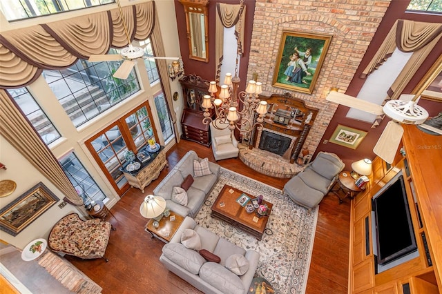 132 Pleasant Valley Dr, Daytona Beach, FL 32114 - living room with a wealth of natural light, a fireplace, a towering ceiling, and wood finished floors