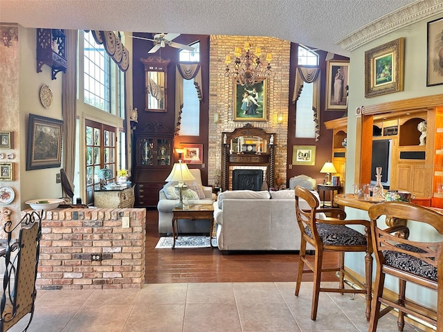 132 Pleasant Valley Dr, Daytona Beach, FL 32114 - tiled living area with a high ceiling, a textured ceiling, a brick fireplace, and ceiling fan