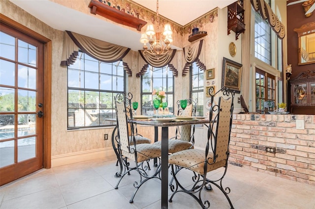 132 Pleasant Valley Dr, Daytona Beach, FL 32114 - dining space with tile patterned floors, baseboards, and a chandelier