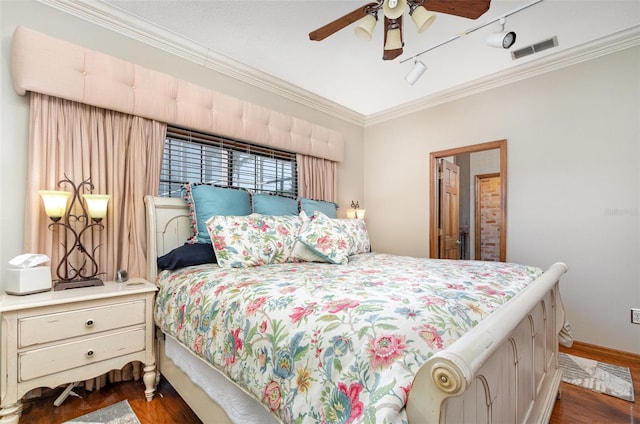 132 Pleasant Valley Dr, Daytona Beach, FL 32114 - bedroom with visible vents, baseboards, ornamental molding, a ceiling fan, and dark wood-style flooring