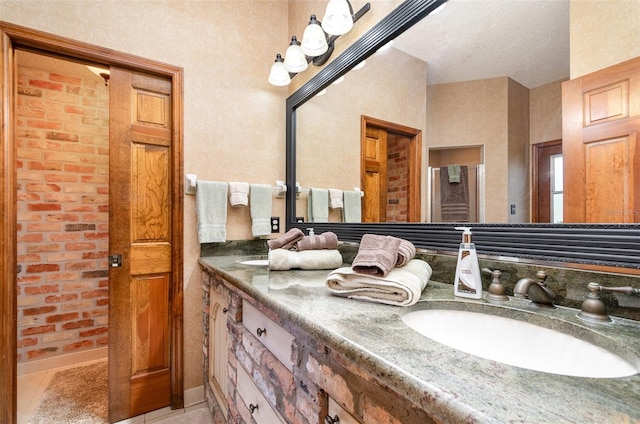 132 Pleasant Valley Dr, Daytona Beach, FL 32114 - full bath with double vanity, tile patterned floors, a textured ceiling, and a sink