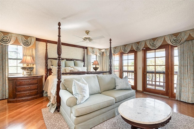 132 Pleasant Valley Dr, Daytona Beach, FL 32114 - bedroom with access to exterior, multiple windows, a textured ceiling, and wood finished floors