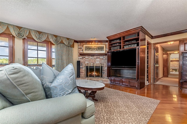 132 Pleasant Valley Dr, Daytona Beach, FL 32114 - living area with a textured ceiling, wood finished floors, a fireplace, and ornamental molding