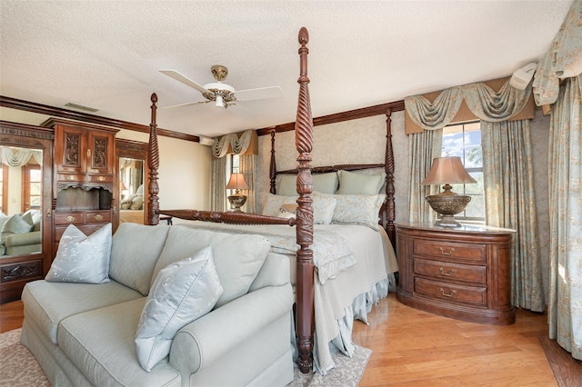 132 Pleasant Valley Dr, Daytona Beach, FL 32114 - bedroom featuring visible vents, ornamental molding, a textured ceiling, light wood finished floors, and ceiling fan