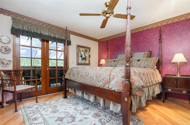 132 Pleasant Valley Dr, Daytona Beach, FL 32114 - bedroom featuring a textured ceiling, wallpapered walls, and wood finished floors