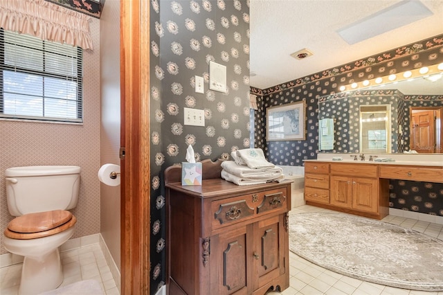 132 Pleasant Valley Dr, Daytona Beach, FL 32114 - bathroom with toilet, wallpapered walls, tile patterned flooring, baseboards, and vanity
