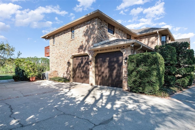132 Pleasant Valley Dr, Daytona Beach, FL 32114 - view of home's exterior featuring a garage, brick siding, and driveway