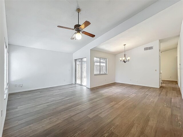 2253 Atrium Cir, Orlando, FL 32808 - unfurnished living room featuring vaulted ceiling, a chandelier, a ceiling fan, wood finished floors, and baseboards