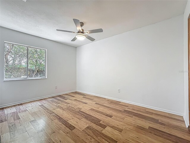 2253 Atrium Cir, Orlando, FL 32808 - empty room with light wood finished floors, ceiling fan, and baseboards