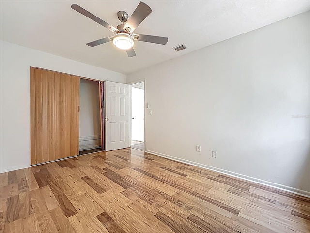 2253 Atrium Cir, Orlando, FL 32808 - unfurnished bedroom with light wood-style flooring, baseboards, a closet, and a ceiling fan
