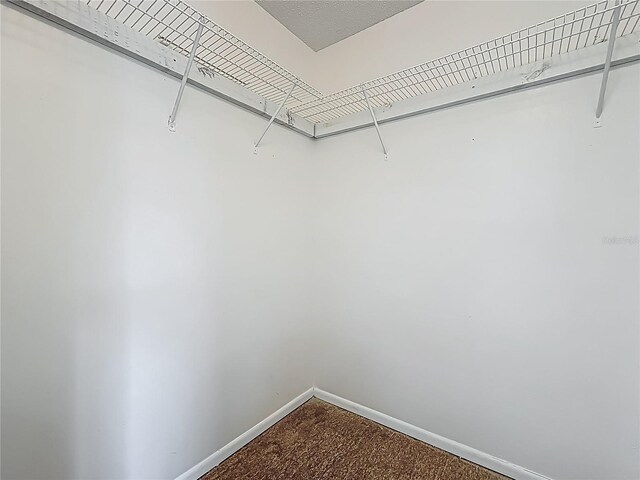 2253 Atrium Cir, Orlando, FL 32808 - walk in closet featuring dark colored carpet