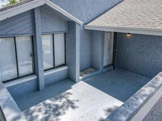 2253 Atrium Cir, Orlando, FL 32808 - doorway to property featuring stucco siding and roof with shingles