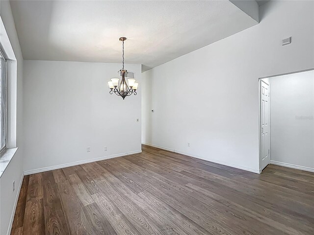 2253 Atrium Cir, Orlando, FL 32808 - unfurnished dining area featuring a chandelier, wood finished floors, and baseboards