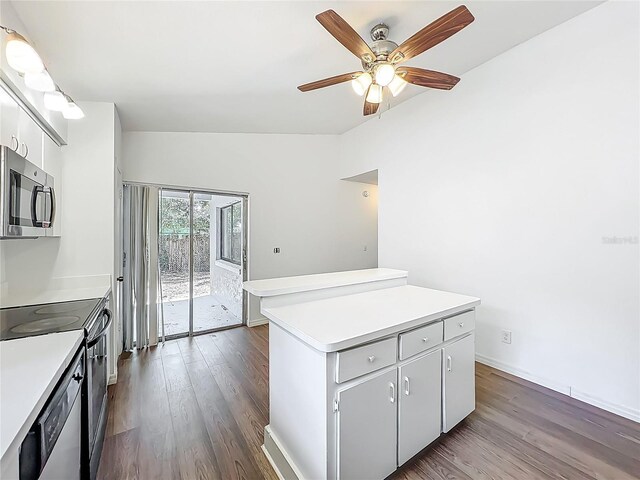 2253 Atrium Cir, Orlando, FL 32808 - kitchen featuring stainless steel microwave, range with electric cooktop, dark wood-type flooring, light countertops, and lofted ceiling