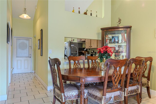 1260 Parkside Green Dr Unit D, Greenacres, FL 33415 - dining room with light tile patterned floors, a high ceiling, and baseboards