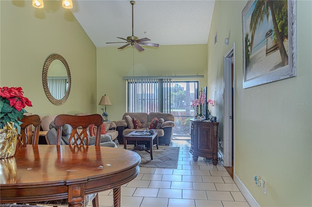 1260 Parkside Green Dr Unit D, Greenacres, FL 33415 - dining space featuring a textured ceiling, light tile patterned floors, baseboards, ceiling fan, and vaulted ceiling