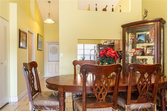 1260 Parkside Green Dr Unit D, Greenacres, FL 33415 - dining area featuring light tile patterned flooring, baseboards, and a towering ceiling