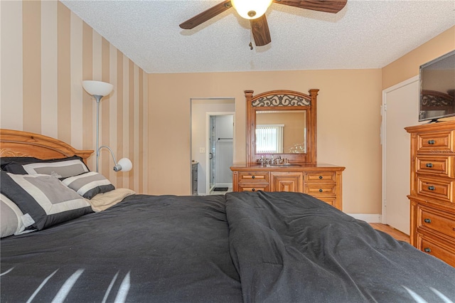 1260 Parkside Green Dr Unit D, Greenacres, FL 33415 - bedroom featuring wallpapered walls, ceiling fan, baseboards, and a textured ceiling