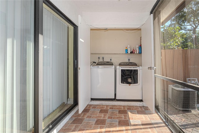 1260 Parkside Green Dr Unit D, Greenacres, FL 33415 - laundry area featuring stone finish flooring, washing machine and dryer, and laundry area