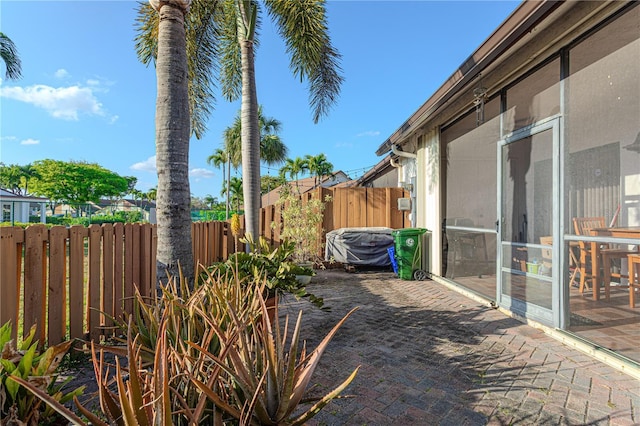 1260 Parkside Green Dr Unit D, Greenacres, FL 33415 - view of patio featuring a sunroom and fence