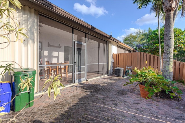 1260 Parkside Green Dr Unit D, Greenacres, FL 33415 - view of patio featuring a sunroom, central AC, and fence