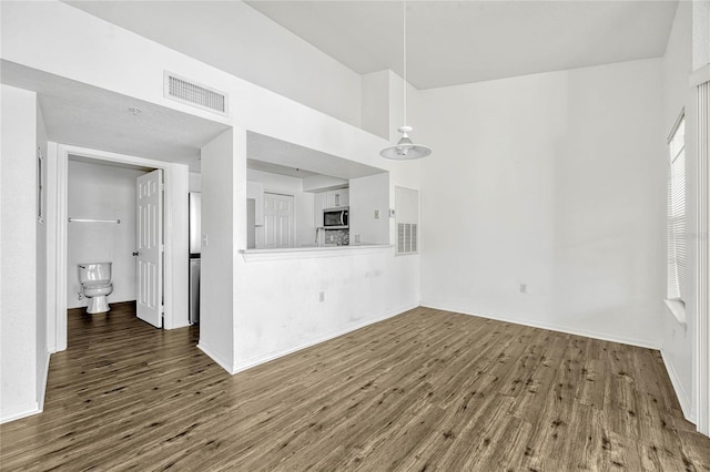 2314 Midtown Ter Unit 1136, Orlando, FL 32839 - unfurnished living room with visible vents, baseboards, and wood finished floors