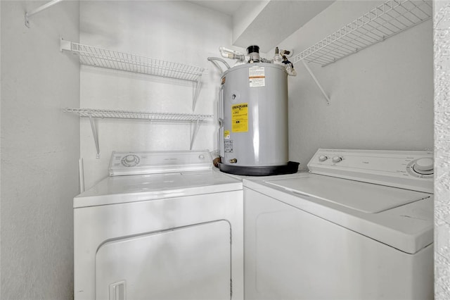 2314 Midtown Ter Unit 1136, Orlando, FL 32839 - laundry room featuring water heater, laundry area, independent washer and dryer, and a textured wall