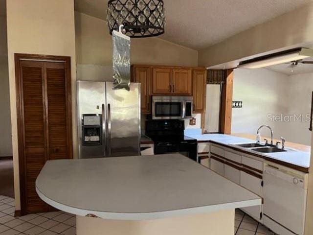 271 Naylor St NE, Palm Bay, FL 32907 - kitchen with stainless steel appliances, a sink, light tile patterned floors, lofted ceiling, and light countertops