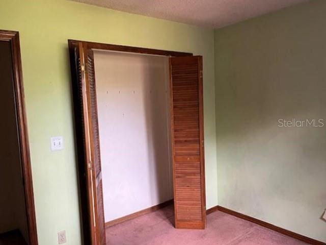 271 Naylor St NE, Palm Bay, FL 32907 - unfurnished bedroom with carpet flooring, baseboards, and a closet
