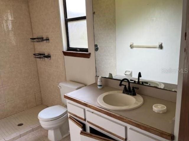 271 Naylor St NE, Palm Bay, FL 32907 - full bathroom with toilet, vanity, tiled shower, and tile patterned floors