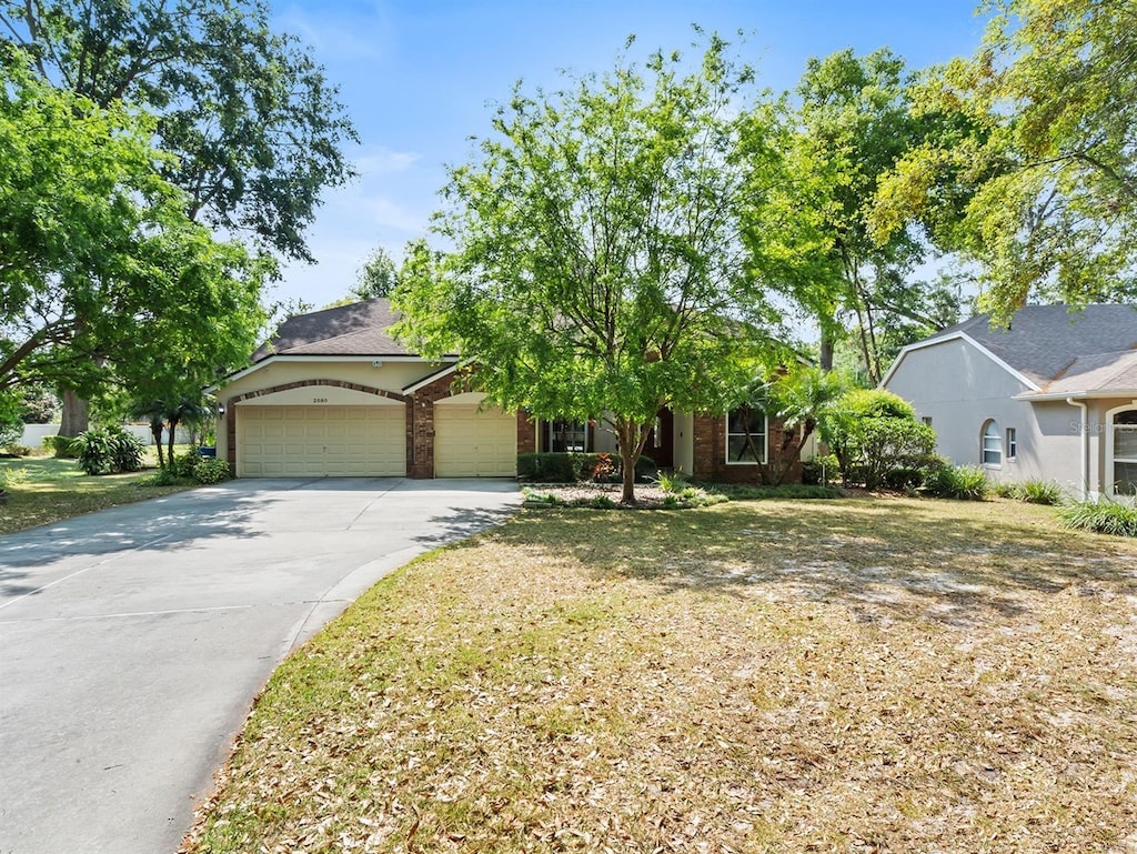 2080 Nexus Ct, Apopka, FL 32712 - view of front of home with a front yard, an attached garage, and concrete driveway