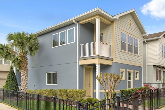 4622 Eureka Ln, Sanford, FL 32773 - view of side of home featuring a balcony, fence, and stucco siding