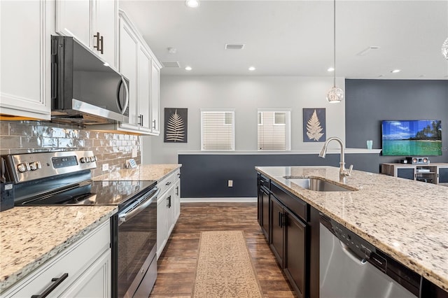 4622 Eureka Ln, Sanford, FL 32773 - kitchen featuring backsplash, light stone countertops, dark wood finished floors, appliances with stainless steel finishes, and a sink