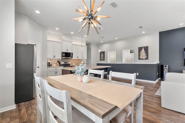 4622 Eureka Ln, Sanford, FL 32773 - dining area with dark wood finished floors, recessed lighting, and visible vents