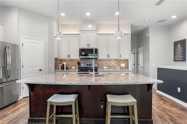 4622 Eureka Ln, Sanford, FL 32773 - kitchen featuring a sink, stainless steel appliances, visible vents, and decorative backsplash