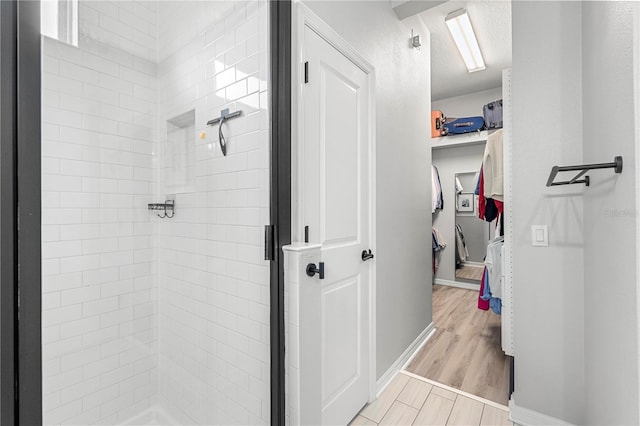 4622 Eureka Ln, Sanford, FL 32773 - bathroom with baseboards, wood finished floors, a closet, and a stall shower