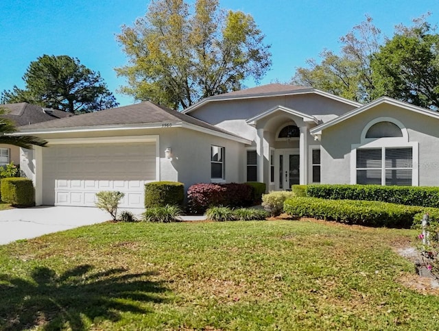 ranch-style house featuring stucco siding, concrete driveway, a front lawn, and a garage