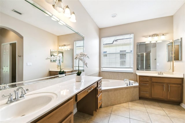 full bath featuring visible vents, a sink, a stall shower, a garden tub, and tile patterned flooring