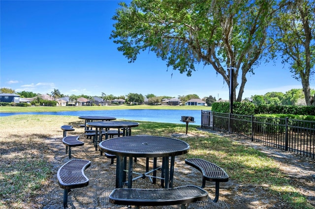 view of yard featuring a water view and fence
