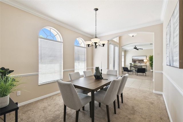 dining area with ceiling fan with notable chandelier, light carpet, crown molding, and baseboards