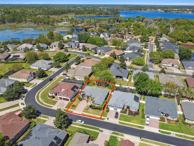 bird's eye view with a residential view, a water view, and a wooded view