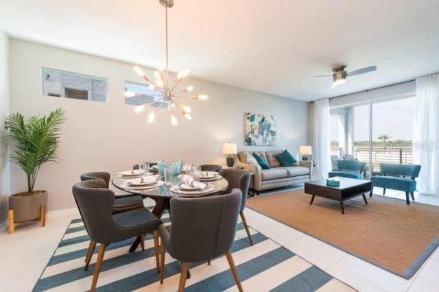 dining area featuring light tile patterned flooring and ceiling fan with notable chandelier