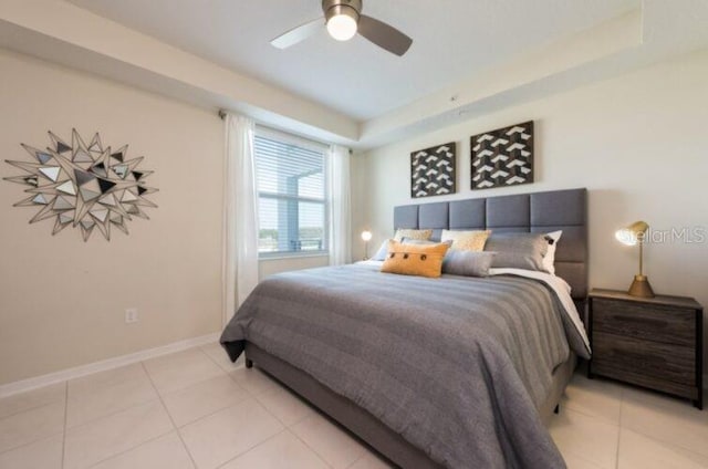 bedroom with light tile patterned flooring, a ceiling fan, and baseboards