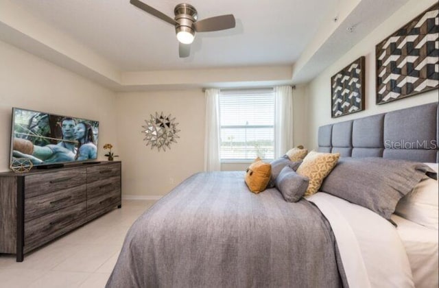 bedroom with light tile patterned flooring, baseboards, and ceiling fan