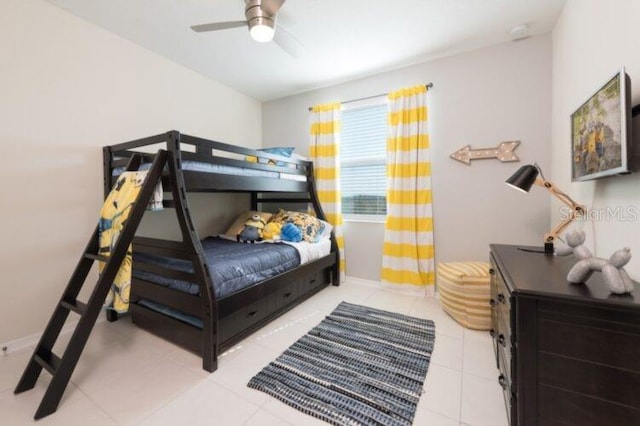 bedroom with tile patterned floors, baseboards, and ceiling fan